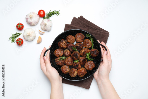 Meatballs in black bowls with spices on a white background
