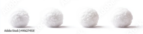 Fluffy white spheres against a plain background