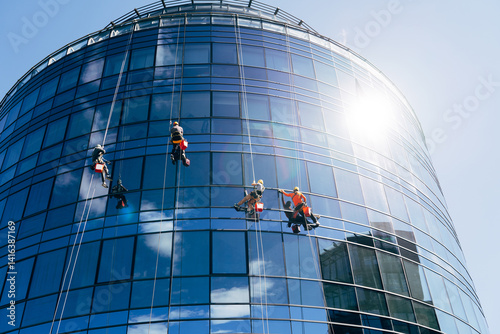 Dedicated Window Cleaners Work on Tall Modern Skyscraper Views
