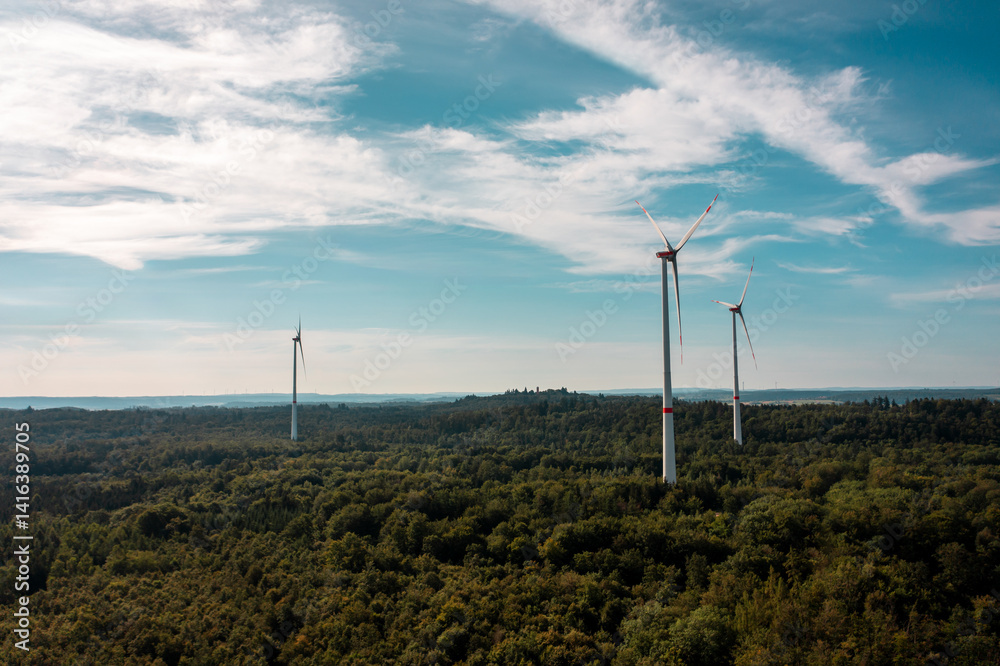 Aerial view shot with wind turbines in the middle of the forest, in Baden Wurttemberg region, Germany Aerial view shot with wind turbines in the middle of the forest, in Baden Wurttemberg region, Germany