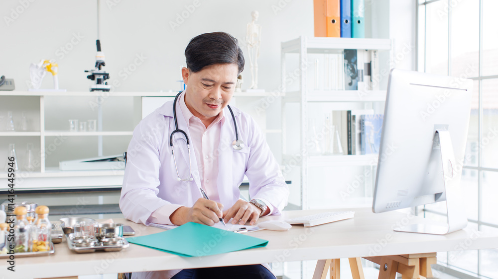 Portrait of asian doctor positive confident consulting sitting at desk working physician wearing stethoscope in clinic hospital using computer writing in notepad online research medical for wellness.