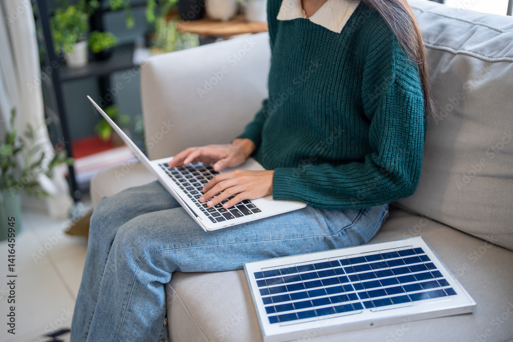 Naklejka premium Asian Woman learning about renewable energy remote control of solar in her house and Installing solar panel sustainable technology