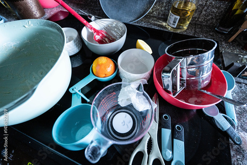 Messy kitchen with dirty dishes after baking. Household chores, kitchen cleanup.