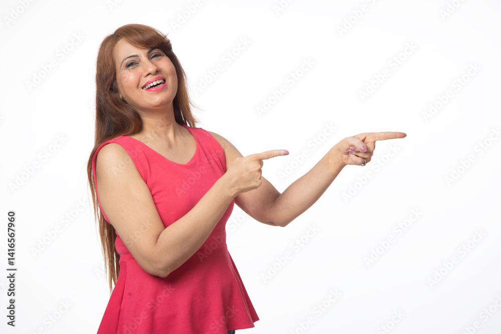 Portrait of happy smiling woman pointing finger isolated on studio background. Indian woman looking at camera pointing at copy space in formal clothes isolated in white Portrait of happy smiling woman pointing finger isolated on studio background. Indian woman looking at camera pointing at copy space in formal clothes isolated in white