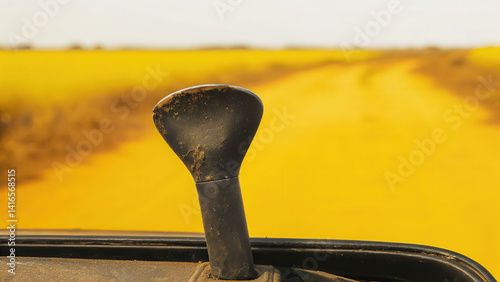 Abandoned car horn half-buried in dirt road remote landscape closeup view symbolizing neglect