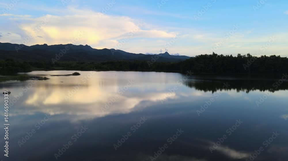 Drone Aerial View of Calm Lake Reflecting Blue Sky and Mountain Range in Northern Thailand – Tranquil Nature Landscape Drone Aerial View of Calm Lake Reflecting Blue Sky and Mountain Range in Northern Thailand – Tranquil Nature Landscape