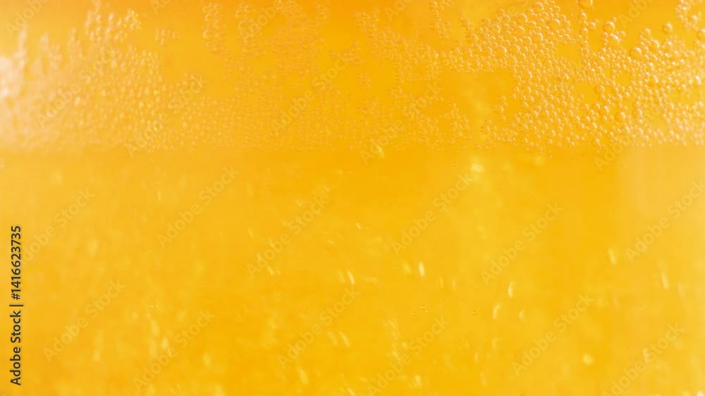 Light, foamy beer, in a filled glass, spins, foams with air bubbles. Close-up. Slow motion. Light, foamy beer, in a filled glass, spins, foams with air bubbles. Close-up. Slow motion.