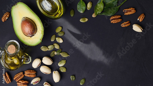 Healthy Assortment: A top-down view showcasing a vibrant array of nourishing food essentials. The scene presents a meticulously arranged selection of avocado, seeds, nuts, and oil
