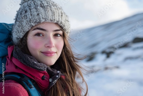 Solo travel, portrait of beautiful young woman in winter clothes, woman traveling alone in winter in mountains. High quality photo