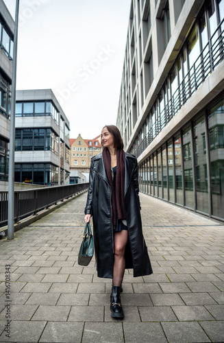 Elegant woman walking in the Stuttgart city, front view