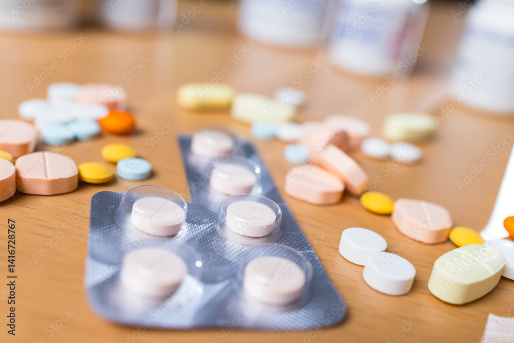 Scattered prescription drugs on brown table