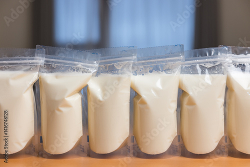 Obraz na płótnie Breast milk storage bags arranged in row w salonie