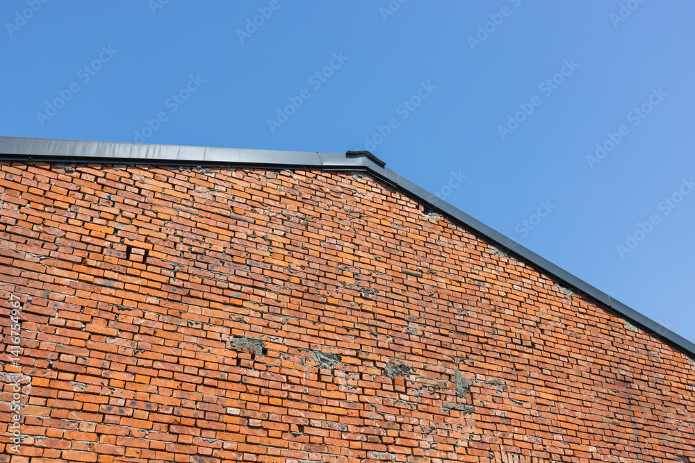 Exterior view of red brick wall building in sunlight