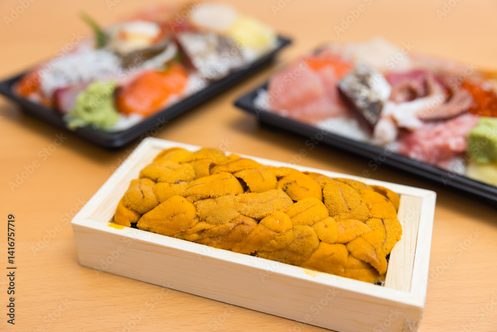 Elegant seafood sashimi bento with uni tray