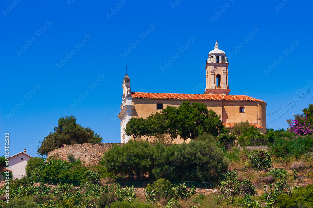 Latin church, in Cargèse, Corsica, France. Typical and picturesque hillside village. Hilltop town nestled on the coast above the Mediterranean sea. Latin church, in Cargèse, Corsica, France. Typical and picturesque hillside village. Hilltop town nestled on the coast above the Mediterranean sea.