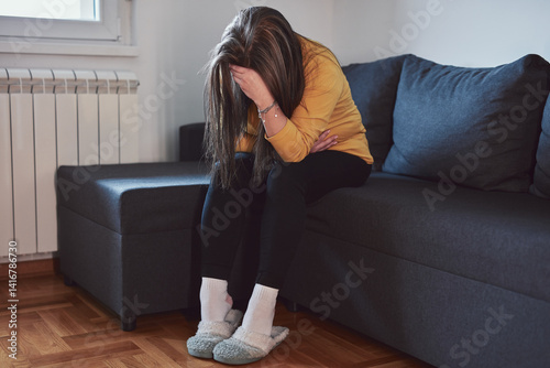 Woman with strong stomach ache, menstrual and digestive issues at home.