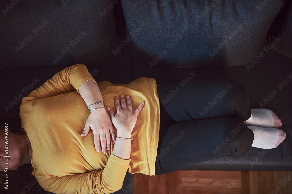 Woman with strong stomach ache, menstrual and digestive issues at home.