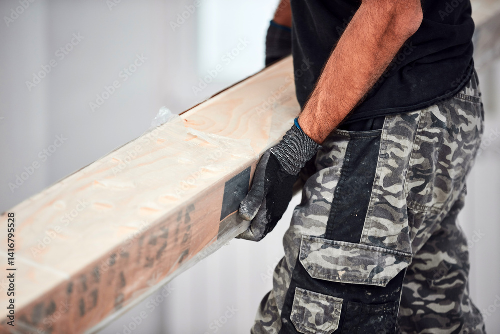 Professional handyman installing laminate flooring in a new apartment.