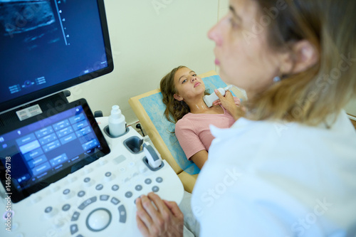 Close up of doctor making thyroid sonogram for kid. Pediatric ultrasound scan. Child ultrasound. Pediatrician scanning neck. Ultrasound examination of lymph nodes. Childhood diseases