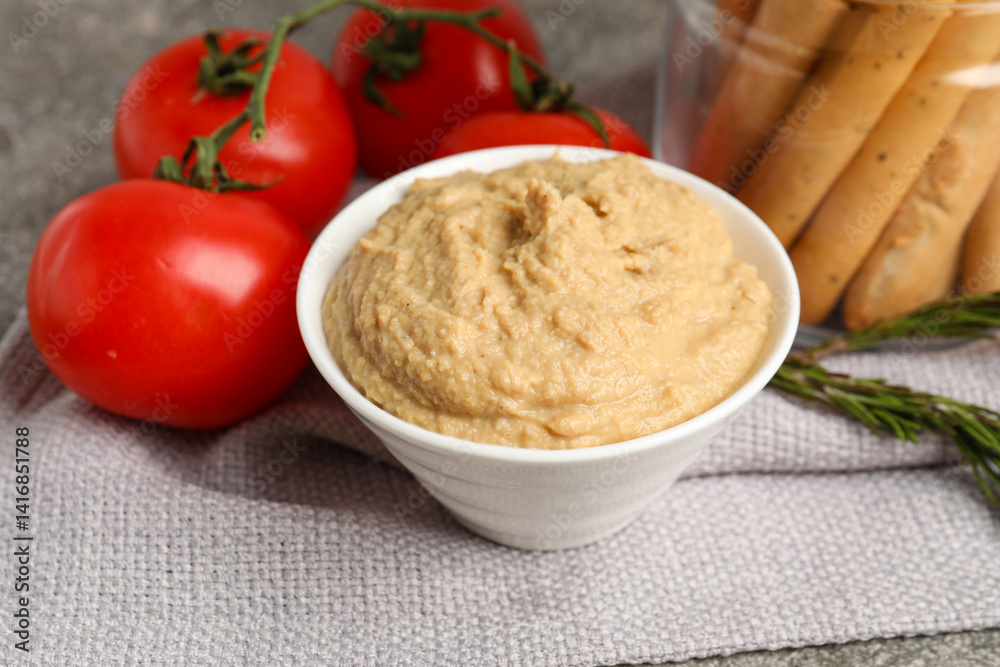 Bowl with tasty hummus on table, closeup Bowl with tasty hummus on table, closeup
