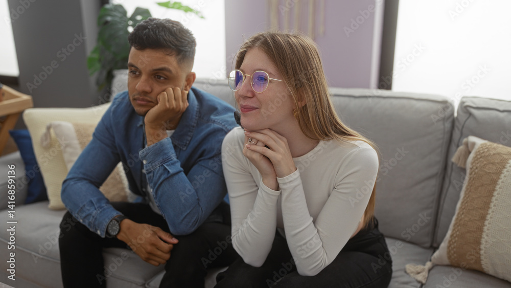 Man and woman sitting together on a comfortable couch in a stylish living room, showcasing a relaxed and intimate moment in a modern apartment interior setting. Man and woman sitting together on a comfortable couch in a stylish living room, showcasing a relaxed and intimate moment in a modern apartment interior setting.