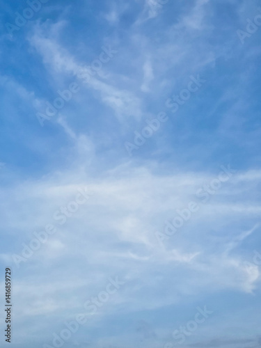 Clear, high-altitude clouds drift across a vibrant azure sky.