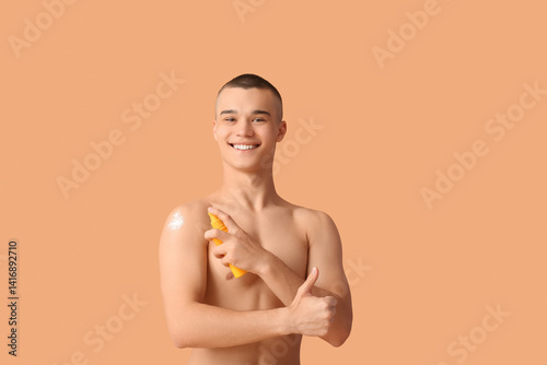 Happy young man applying su...