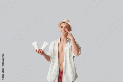 Happy young man applying su...