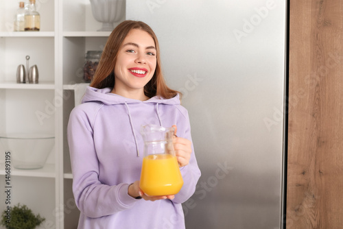 Young woman with jug of ora...