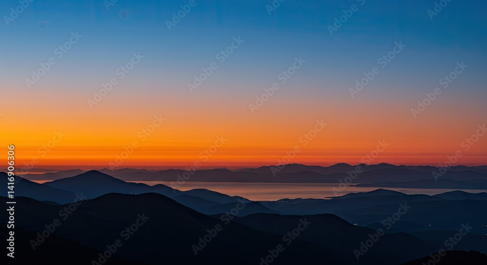 Obraz premium Serene Sunrise Over Majestic Mountains and Calm Waters