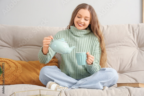 Young woman pouring tea int...