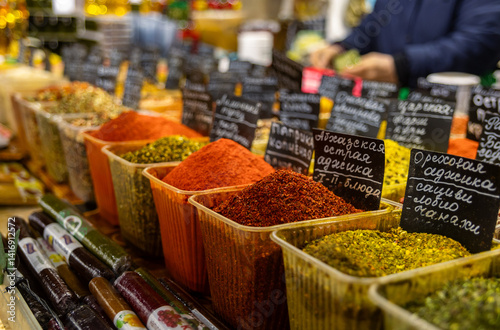 Fototapeta Naklejka Na Ścianę i Meble -  Various spices, peppers and herbs close-up top view. Eastern spice market. A set of peppers and spices for cooking. Assortment of various oriental spices on the counter at the Asian bazaar in close-up