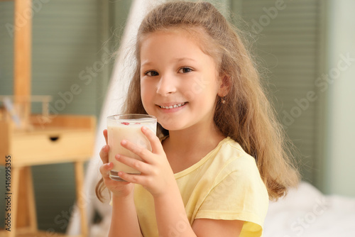 Smiling little girl holding...
