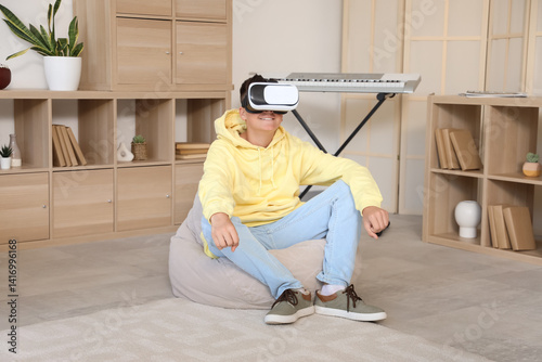 Teenage boy using VR glasse...