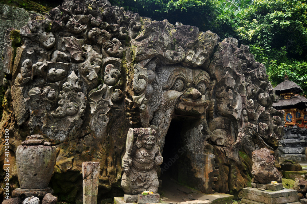 Ancient sculpture carving gate entrance tunnel of Goa Gajah or Elephant Cave significant Hindu archaeological site for travelers people travel visit and respect praying at Ubud city in Bali, Indonesia Ancient sculpture carving gate entrance tunnel of Goa Gajah or Elephant Cave significant Hindu archaeological site for travelers people travel visit and respect praying at Ubud city in Bali, Indonesia