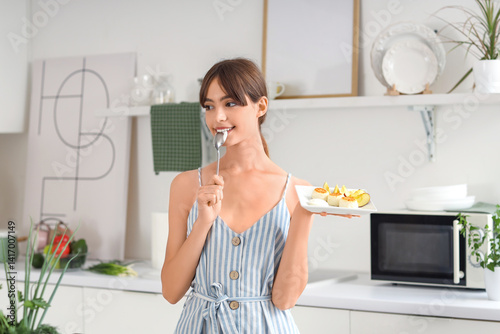 Young woman eating tasty co...