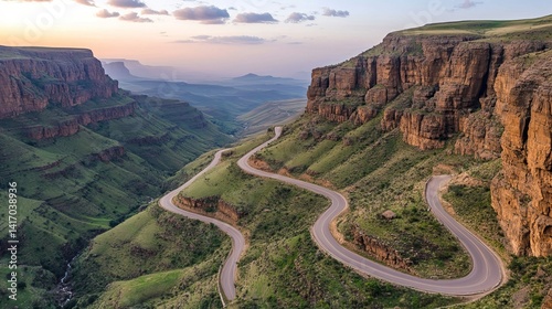 Top view of winding mountain road carved into dramatic landscape