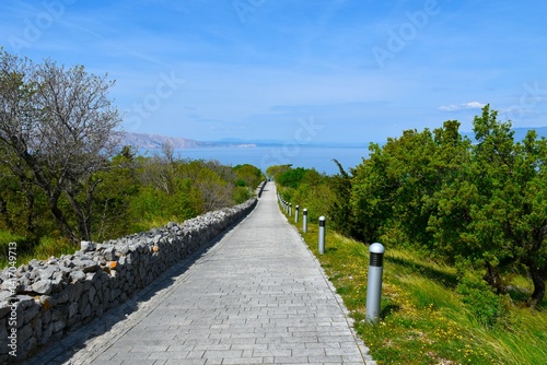 Trail leading through Nehaj park in Senj, Croatia with the Adriatic sea behind