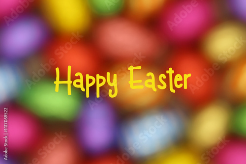 Easter card with text Happy Easter. Blurred background of Easter eggs.