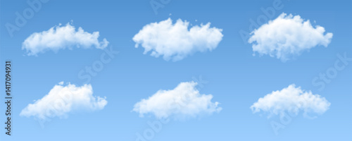 Realistic white fluffy cloud set isolated on light blue background. Collection of abstract clouds of various shapes.