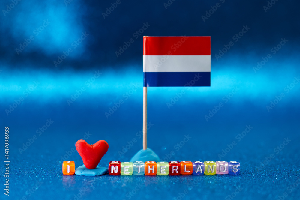 Colorful decorations displaying love for Netherlands with a small flag and heart on a vibrant blue surface during an artistic arrangement