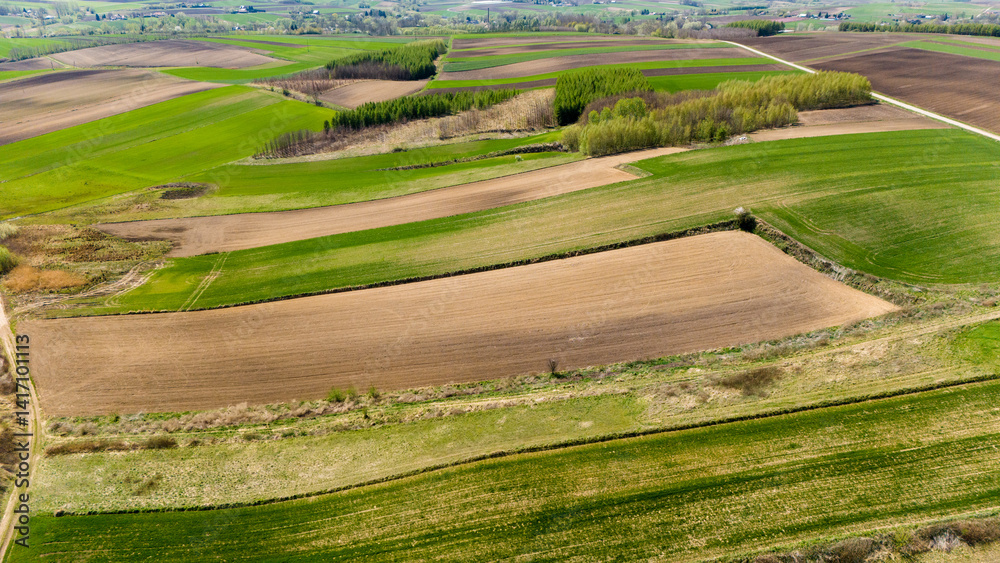 drone footage of rural farm fields in full color..