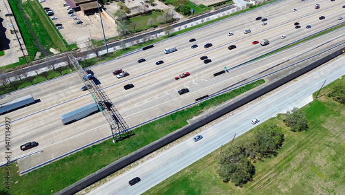Busy traffic along Sam Houston Tollway in Westchase business district, Western Houston, Texas, multiple vehicles include semi-trucks, cars, trailers on freeway, electronic toll collection, aerial