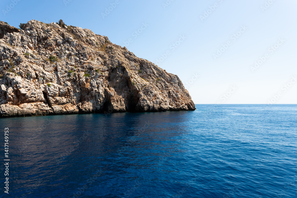 Fototapeta premium The rocky coastline of the island, in the middle of the sea in Turkey. The seascape is mesmerizing with its view and the beauty of nature.