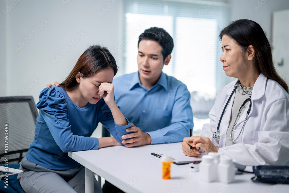 A woman is crying in front of a doctor and a man A woman is crying in front of a doctor and a man