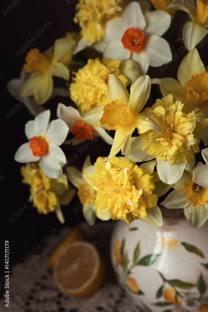 Still-life. Photo of a bouquet of daffodils with lemons. Still-life. Photo of a bouquet of daffodils with lemons.
