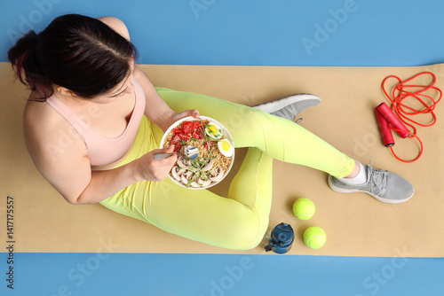 Sporty young woman sitting ...