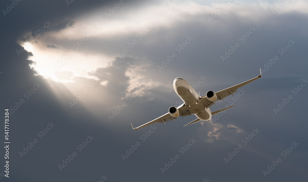 White passenger airplane flying in the sky amazing clouds in the background at sunset - Travel by air transport