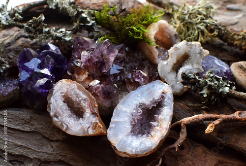 Precious amethyst crystals on wooden background, healing crystals. Beautiful violet quartz druse and geodes.