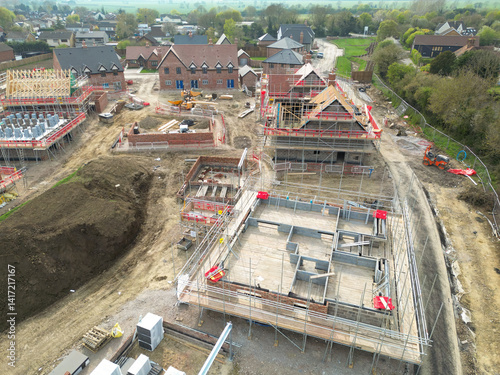 Obraz na płótnie Low level aerial view of partially completed new homes on a housing development site in rural Britain. Both private and affordable homes will be for sale in this village. w salonie